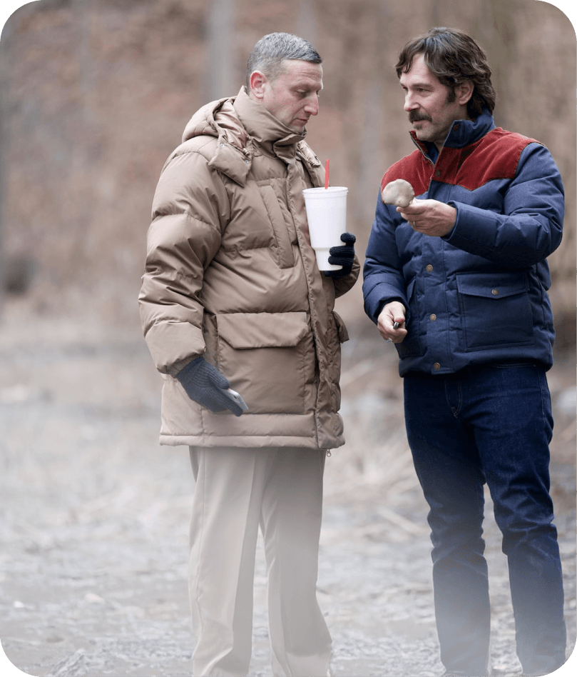 Friendship — two men in winter coats sharing a quiet exchange